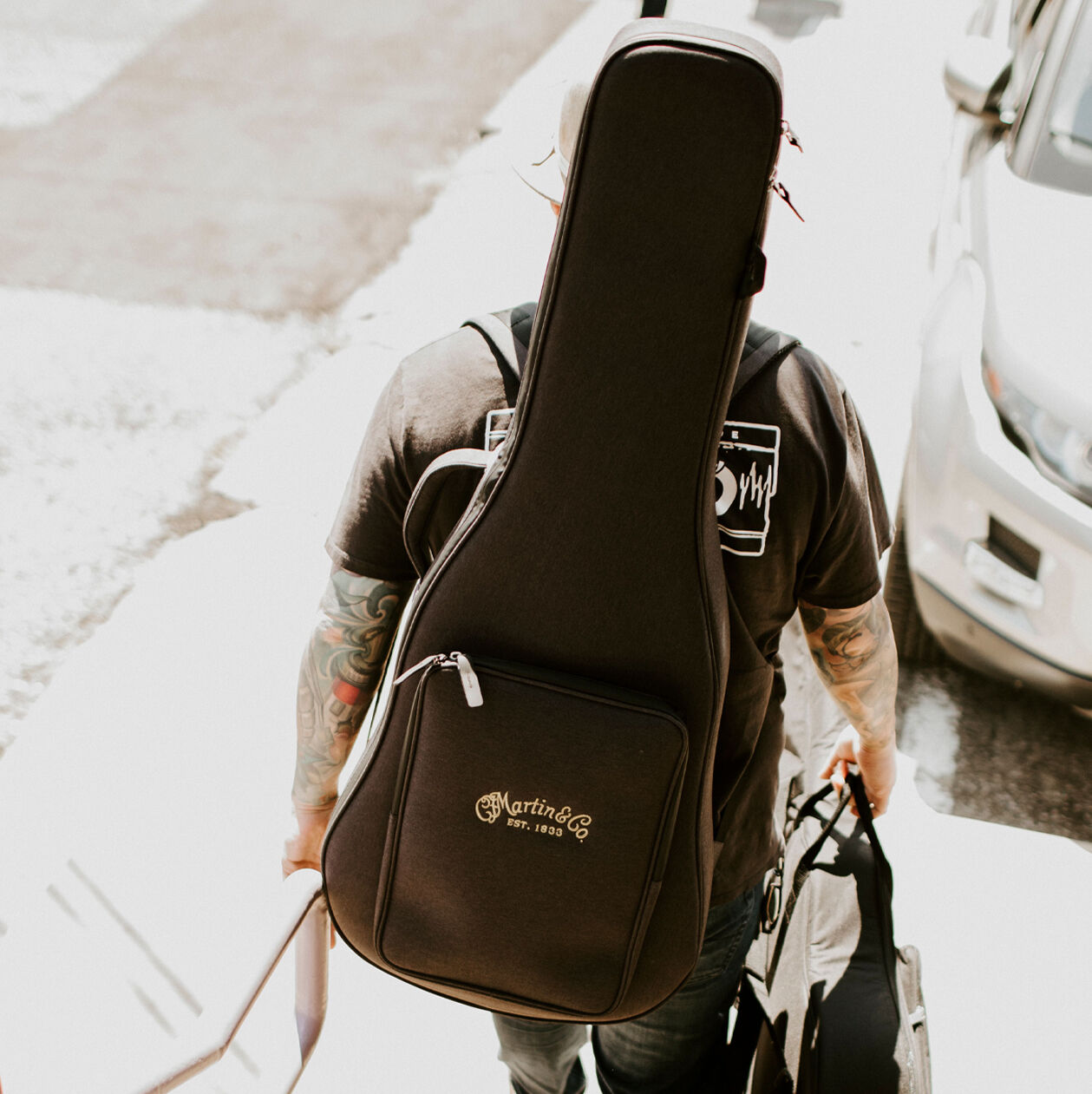 Person with a guitar case on their back